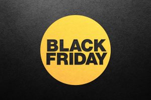 The words "BLACK FRIDAY" in bold black text inside a large yellow circle, centred on a dark, textured charcoal background.