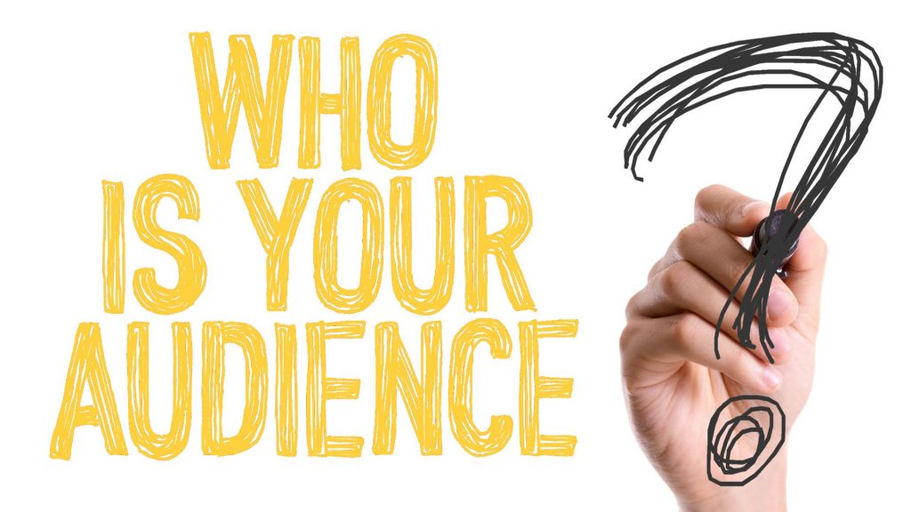 Handwritten yellow text on a white background asking 'WHO IS YOUR AUDIENCE' with a large, drawn question mark.
