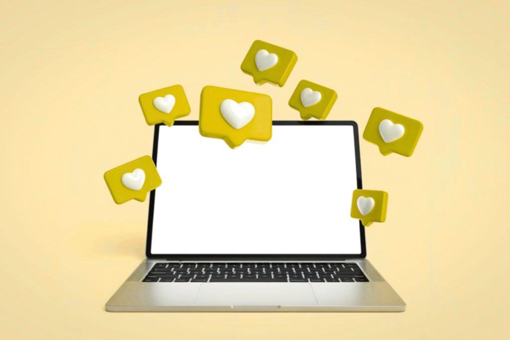 A 3D illustration of a laptop with several yellow heart notification bubbles floating around the screen.