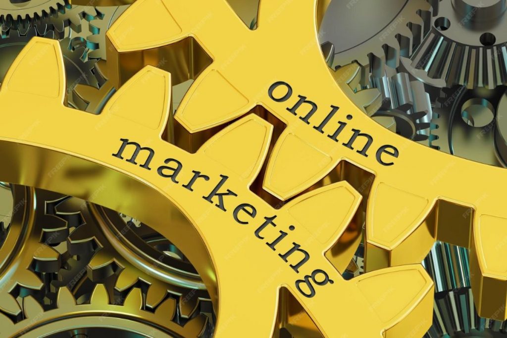 A close-up, top-down view of several interlocking silver and gold metal gears resting on a dark surface.